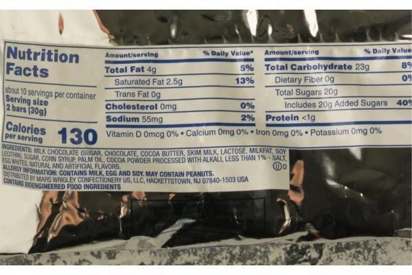 Are Three Musketeers gluten free? Close-up of the ingredients list on a Three Musketeers candy wrapper.