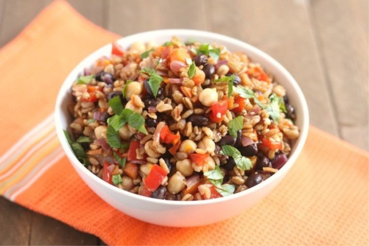 A colorful bowl of farro salad, showcasing one of the best ways to eat Farro, a versatile grain.